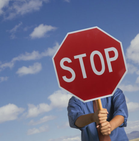 Man holding a stop signboard